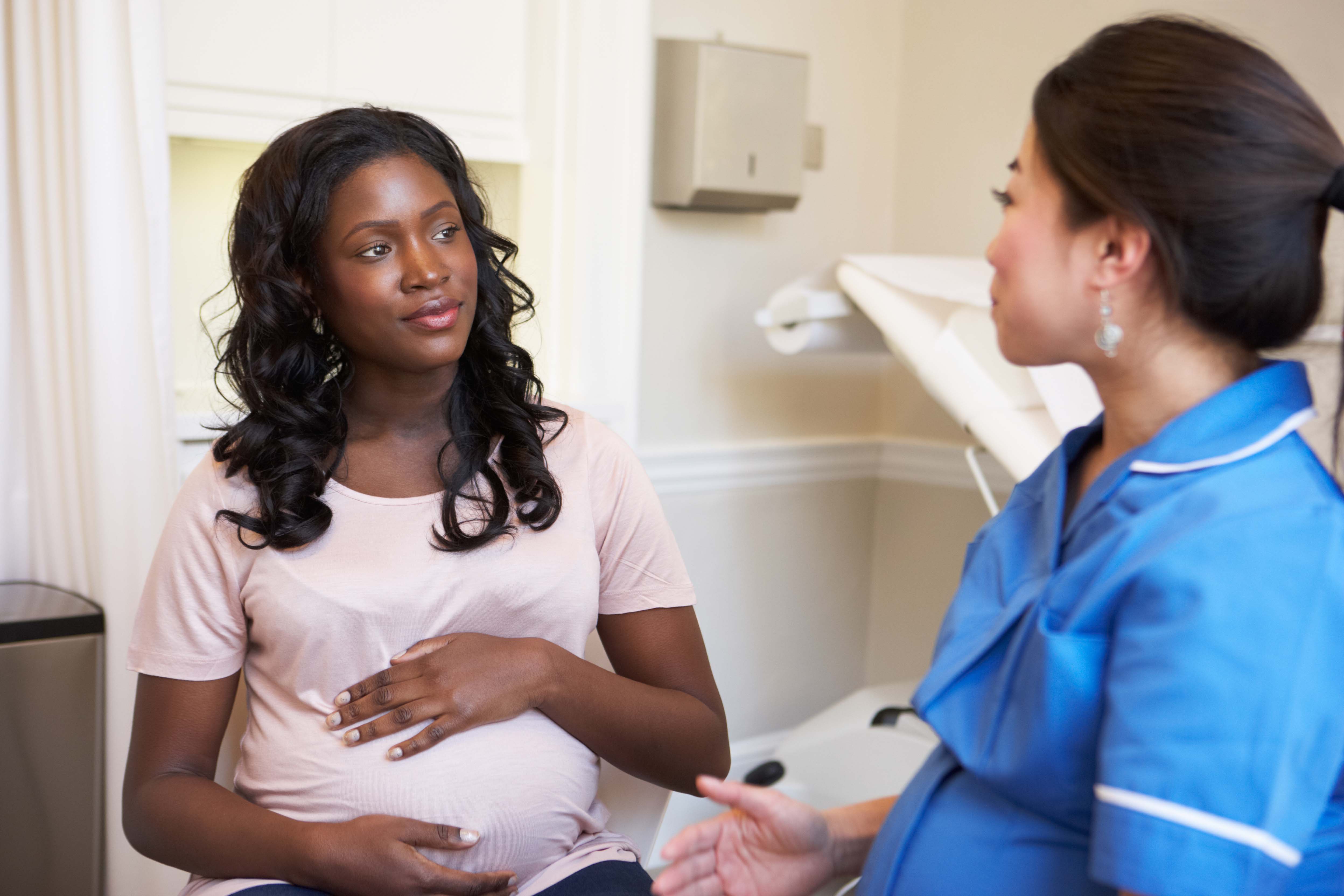 A pregnant mother consulting her provider. 