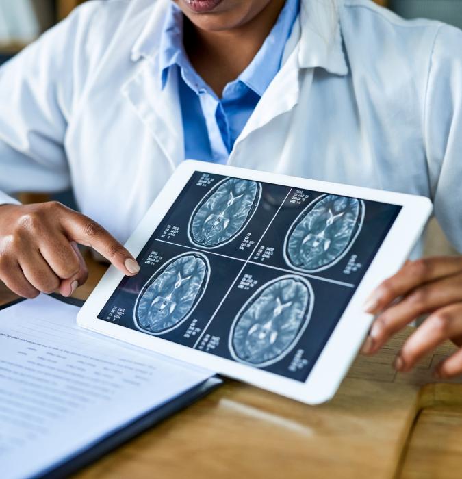 Provider explaining neurology scans to patient