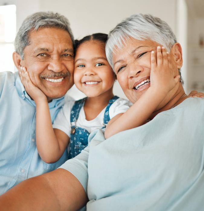 Shot of grandparents bonding with their granddaughter on a sofa at home